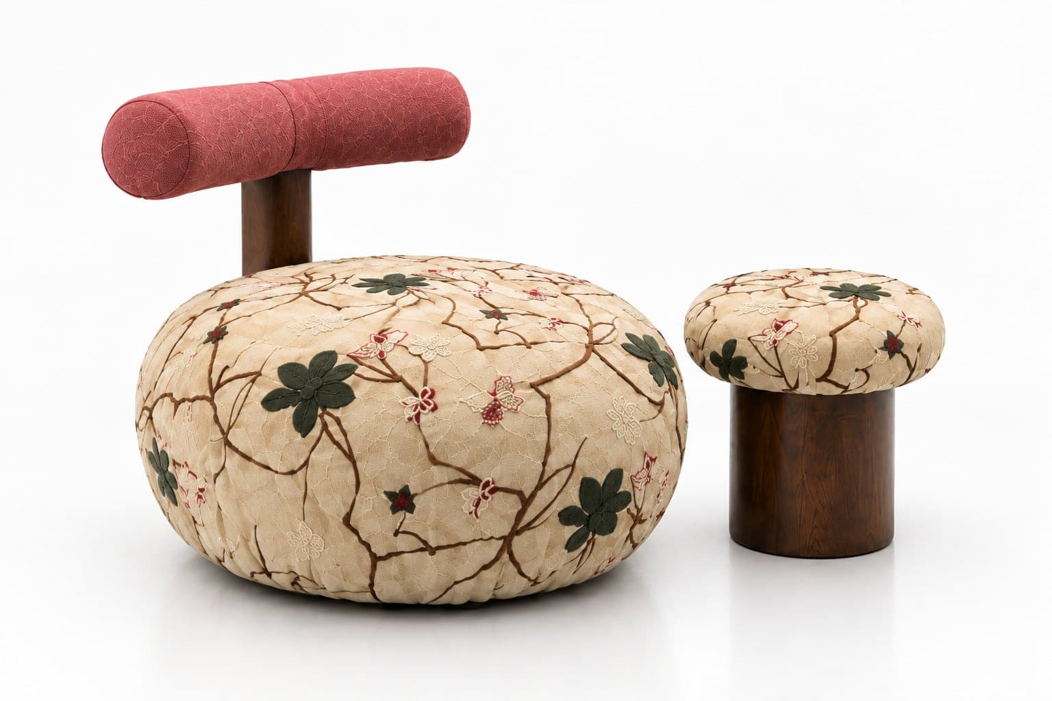 A round embroidered chair in cream with a rose bolster backrest on a turned walnut post, beside a matching embroidered stool