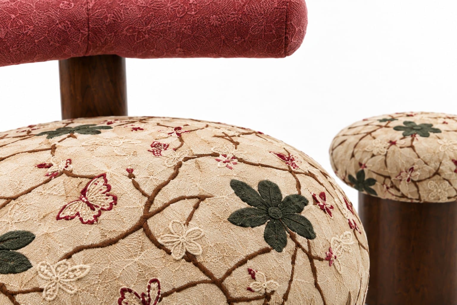 Close-up of the embroidery — vines, butterflies and green leaves worked on cream fabric