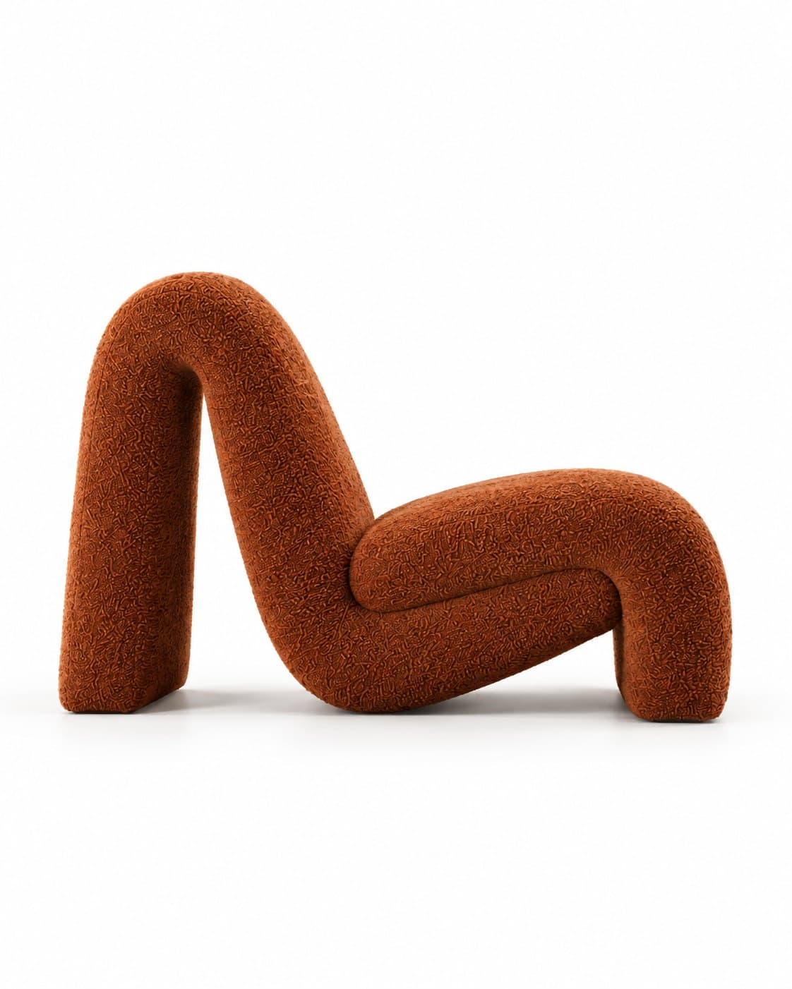 The lounge chair in profile, showing the single band curling over at the top of the back and rolling down at the front of the seat